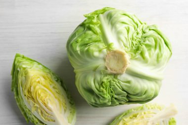 Taze taze lahana ve açık ahşap masa üzerinde kesilmiş lahanalar.