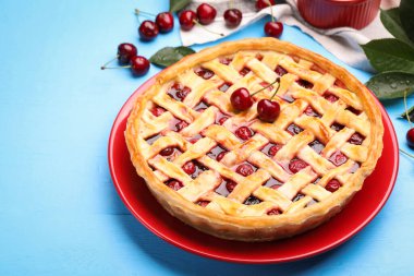 Açık mavi ahşap masada vişneli turta, yakın plan.