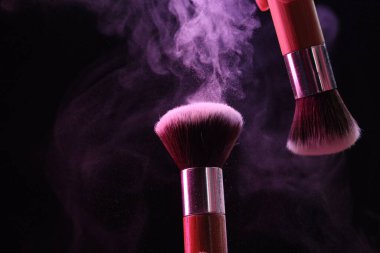 Siyah arkaplanda renk farlı makyaj fırçaları, yakın plan