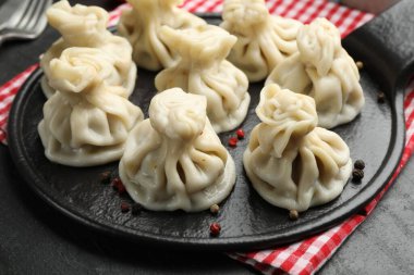 Siyah masadaki baharatlı lezzetli khinkali, yakın plan.