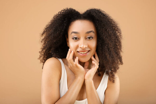 Portrait of beautiful Brazilian woman on beige background