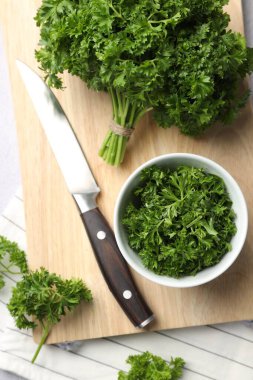 Taze maydanoz ve bıçak masanın üzerinde, düz yatıyordu.