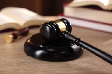 Yargıç tokmağı ve ahşap masa üzerindeki kitaplar, seçici odaklanma.