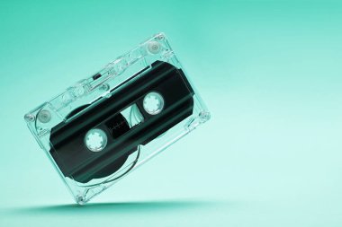 Turkuaz arka planda bir ses kaseti, yakın plan. Metin için boşluk