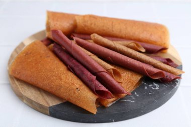 Lezzetli meyve dürümleri beyaz masada, yakın plan.