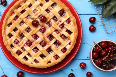 Lezzetli kirazlı turta ve böğürtlen açık mavi ahşap masa, düz uzanmış