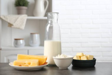 Mutfaktaki gri desenli masada farklı süt ürünleri.