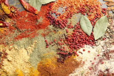 Gri masada farklı aromatik baharatlar, üst görünüm.