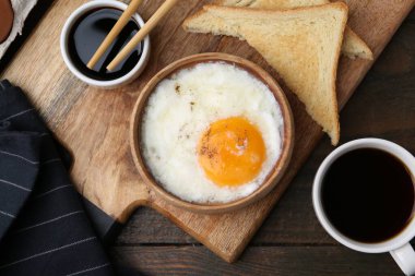 Tabakta yarı haşlanmış yumurta, soya sosu, yemek çubukları, kahve ve ahşap masada kızarmış ekmek, düz yatak. Geleneksel Asya kahvaltısı
