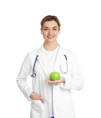 Beyaz arka planda yeşil elmalı ve steteskoplu beslenme uzmanı.