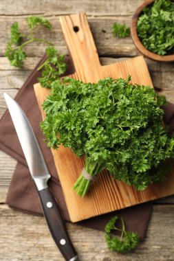 Taze maydanoz ve bıçak ahşap masada, düz yatıyordu.