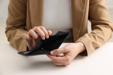 Beyaz masadaki boş cüzdanlı kadın, yakın plan.