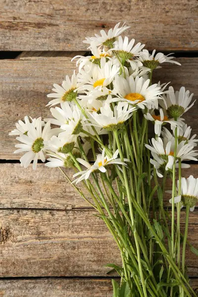Tahta masanın üzerinde bir sürü güzel papatya çiçeği vardı.