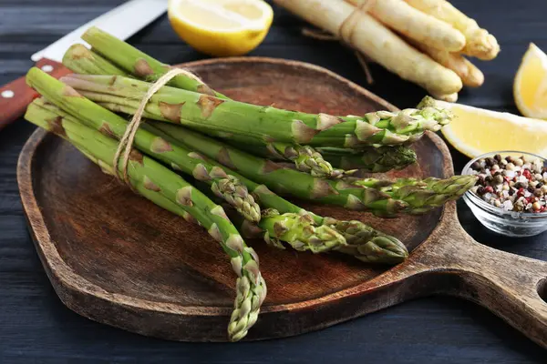 Farklı çiğ kuşkonmaz mızrakları, baharatlar ve bıçak.