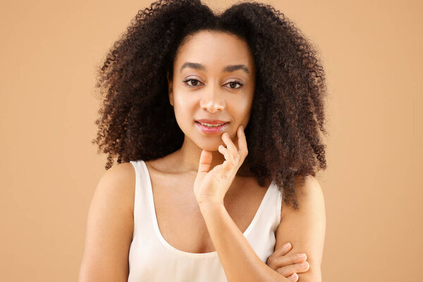 Portrait of beautiful Brazilian woman on beige background