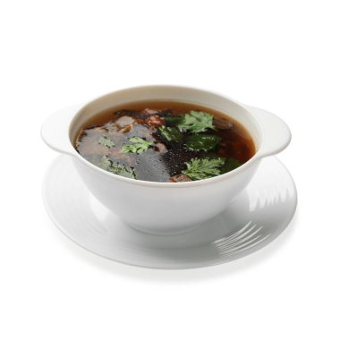 Mantarlı lezzetli çorba ve beyaz tenceredeki maydanoz.