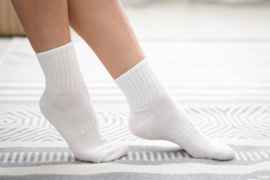 Beyaz çoraplı kadın evde yerde, yakın plan.