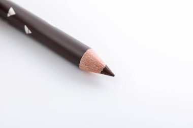 Beyaz arka planda kahverengi kaş kalemi, yakın plan. Metin için boşluk