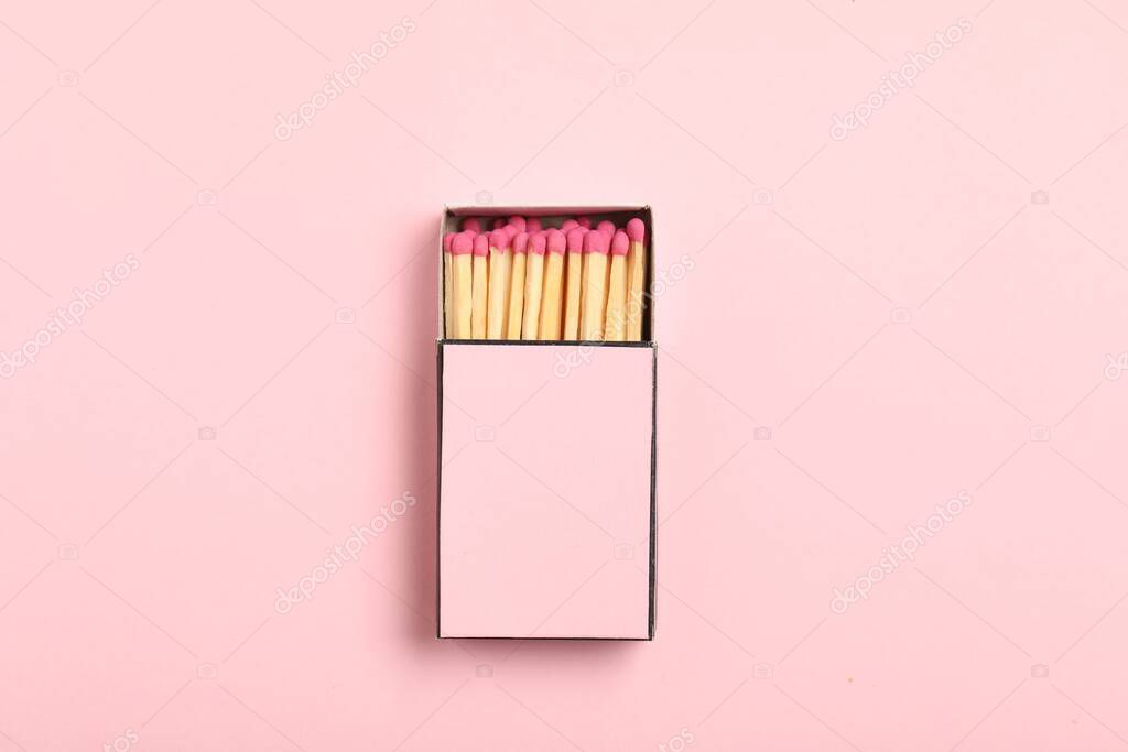 Matches in box on pink background, top view. Mockup for design