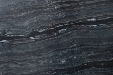 Arkaplan olarak koyu mermer yüzeyin dokusu, üst görünüm