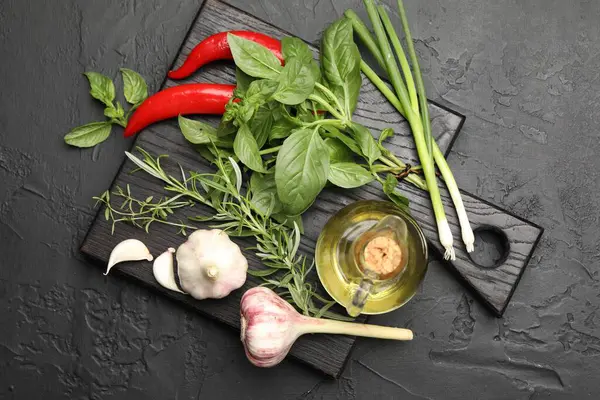 Siyah masada farklı taze otlar ve baharatlar.