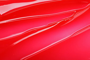 Arka plan olarak kırmızı dudak parlatıcısının dokusu, üst görünüm