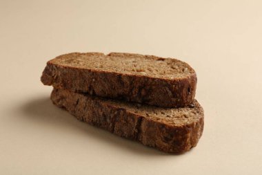 Bej arka planda taze çavdar ekmeği parçaları, yakın plan.