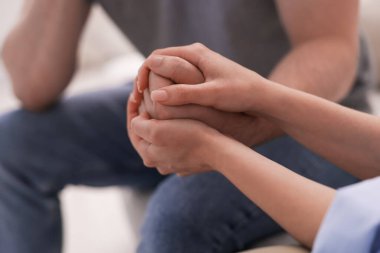 Ofisteki terapi seansında hastaya destek veren psikolog, yakın çekim.