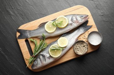 Siyah masadaki baharatlı taze çiğ deniz kabuğu. Balık ve deniz ürünleri lezzetleri