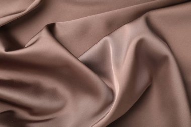 Arkaplan olarak buruşuk açık kahverengi ipek kumaş, üst görünüm