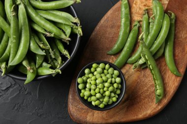 Taze taze bezelyeler siyah masada, düz yatıyordu.
