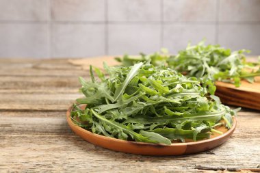 Taze yeşil roka yaprakları ahşap masada, yakın plan. Metin için boşluk