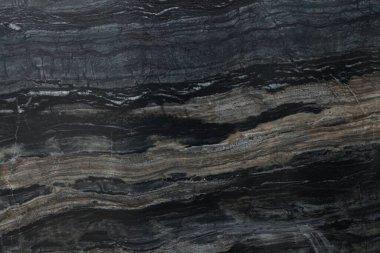 Arkaplan olarak koyu mermer yüzeyin dokusu, üst görünüm
