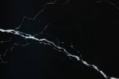 Arkaplan olarak siyah mermer yüzey dokusu, üst görünüm