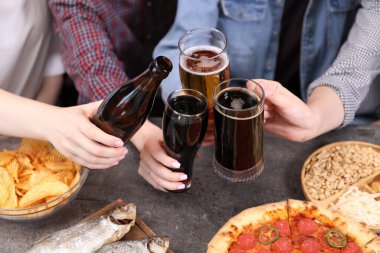 Gri masada bira ve atıştırmalık arkadaşlar, yakın plan.