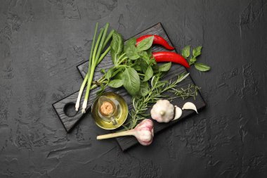 Siyah masada farklı taze otlar ve baharatlar.