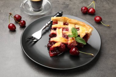 Gri masadaki lezzetli vişneli turta ve böğürtlen, yakın plan.