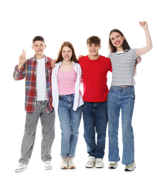 Excited teenagers posing together on white background