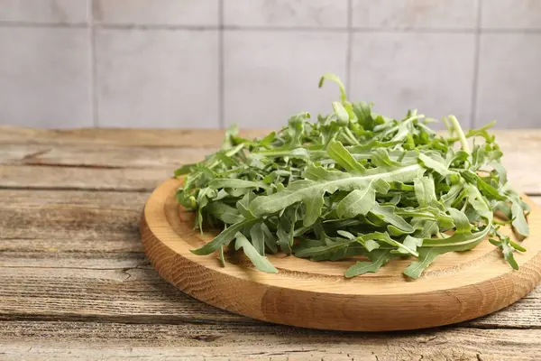 Taze yeşil roka yaprakları ahşap masada, yakın plan. Metin için boşluk