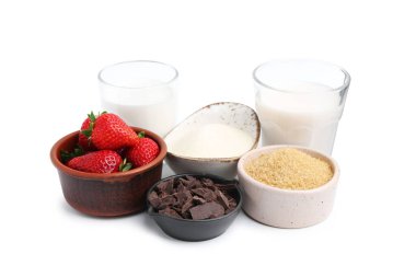 Panna cotta için farklı malzemeler. Beyaz üzerine izole edilmiş süt, şeker, vanilya, çikolata ve çilek.