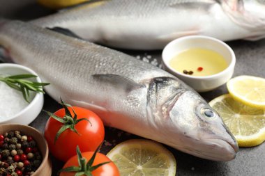 Gri masadaki baharatlı taze çiğ deniz kabuğu, yakın plan. Balık ve deniz ürünleri lezzetleri