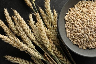 Siyah masanın üzerinde bir sürü buğday ve tahıl var.