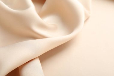 Arka plan olarak buruşuk bej ipek kumaş, yakın plan. Metin için boşluk