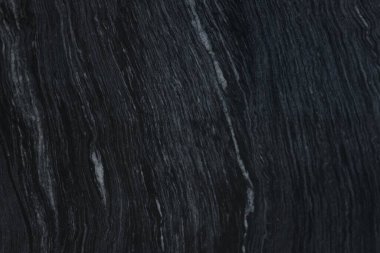 Arkaplan olarak koyu mermer yüzeyin dokusu, üst görünüm