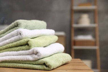 Tuvaletteki ahşap masada temiz havlular, yakın plan. Metin için boşluk