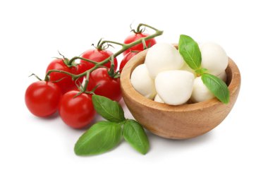 Lezzetli mozzarella peynir topları, domates ve fesleğen beyaza izole edilmiş.