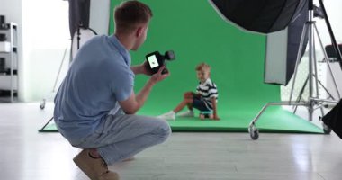 Profesyonel fotoğraf stüdyosunda modelle çalışan bir fotoğrafçı.