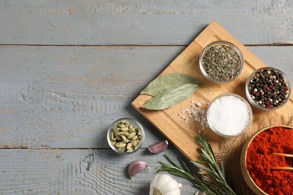 Gri ahşap masadaki farklı aromatik baharatlar. Metin için boşluk