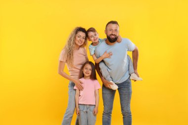 Sarı arka planda mutlu aile portresi