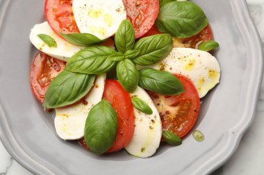 Peynirli, domatesli, fesleğenli ve baharatlı Caprese salatası.